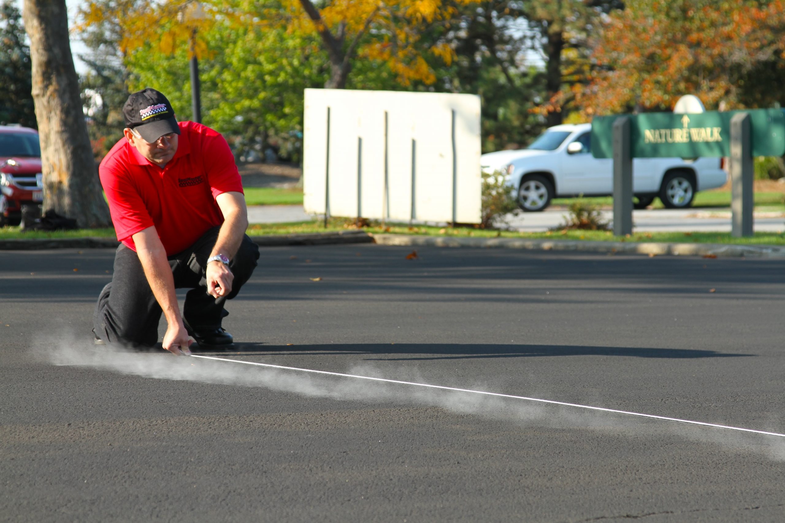 Measuring and marking a parking lot with chalk before applying traffic marking paint. Learn how to stripe a parking lot.