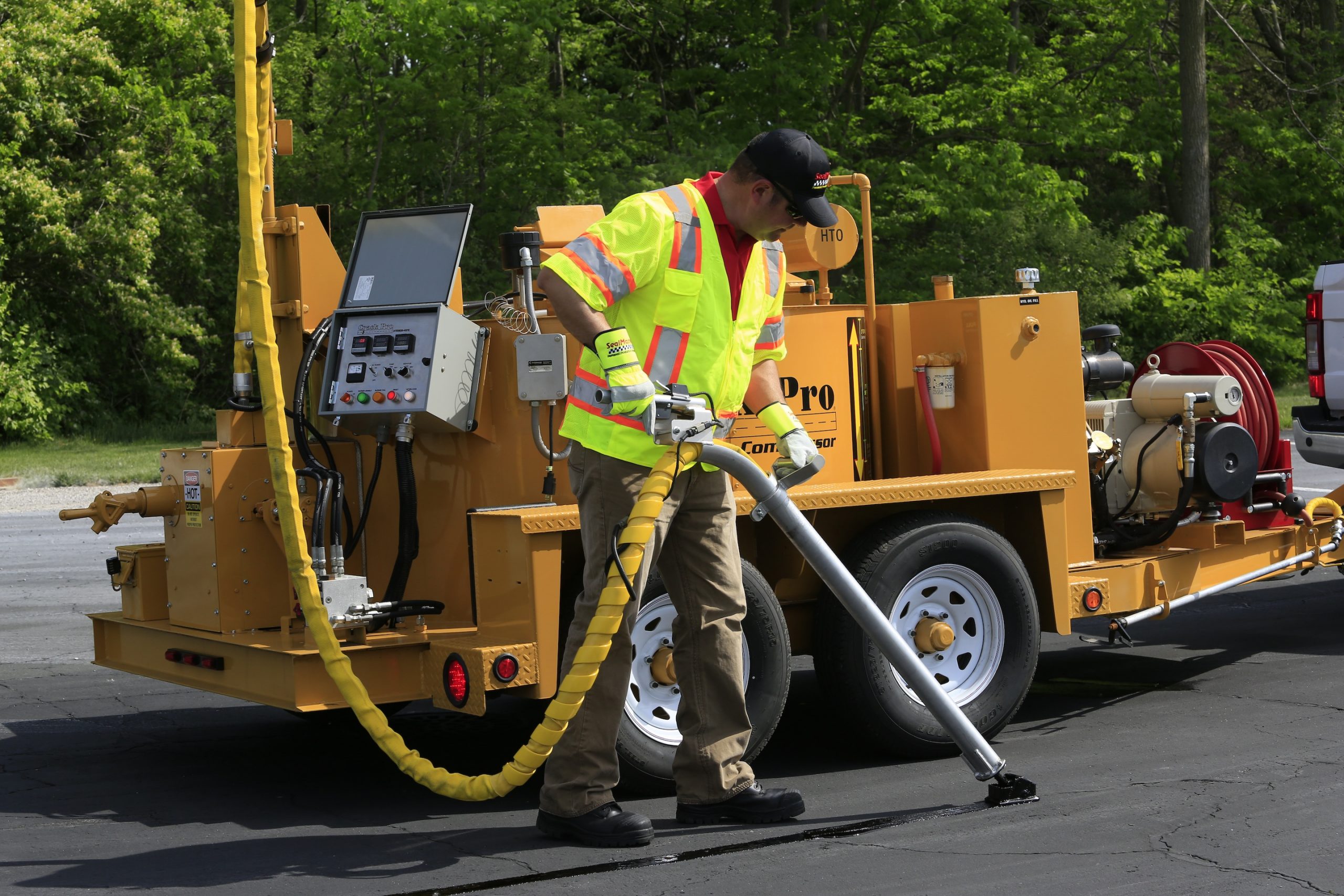 CrackPro 260 Heated Hose Machine, an oil-jacketed melter/applicators for hot pour crack sealing materials, applying material.