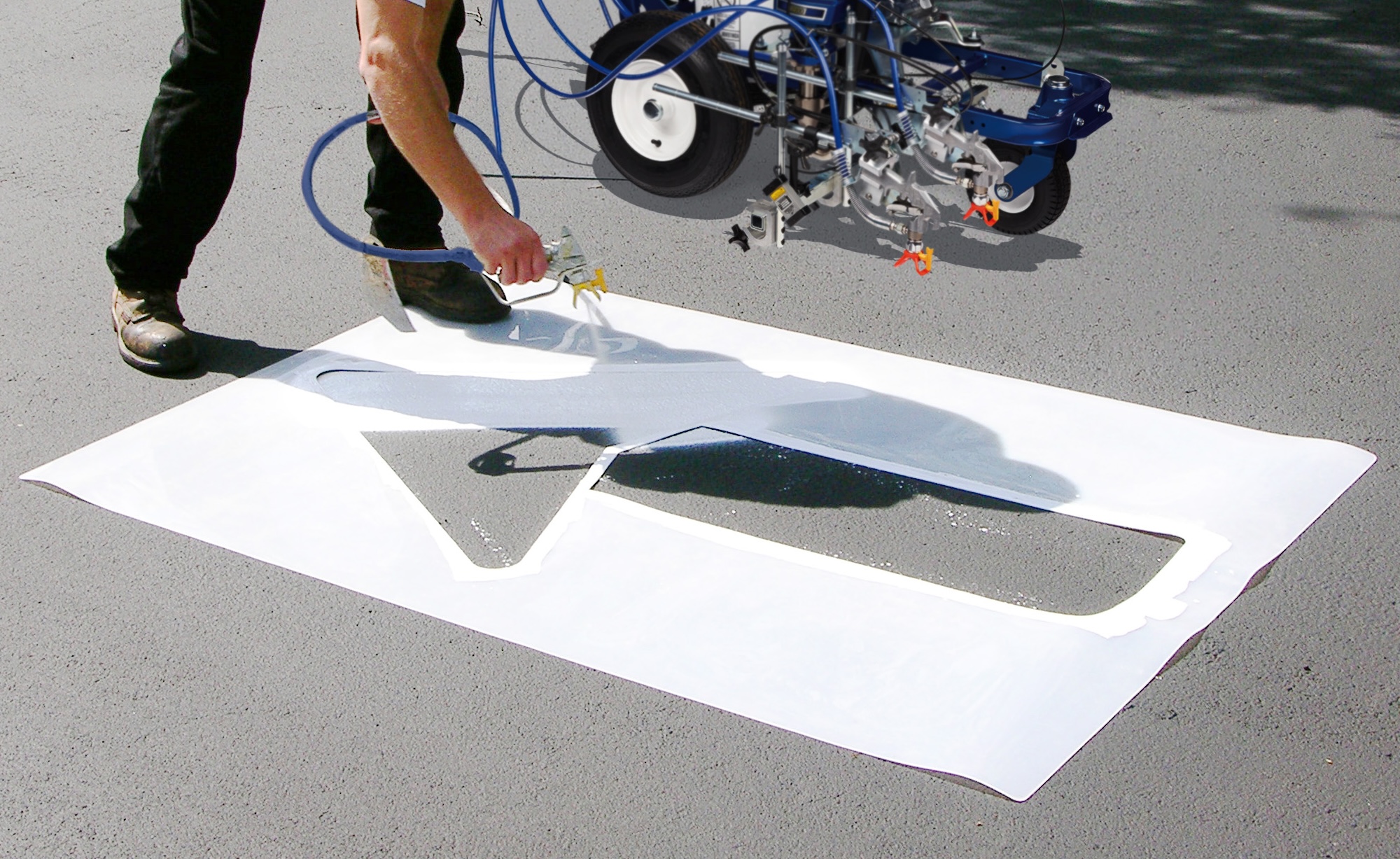 Applying traffic marking paint to asphalt pavement.