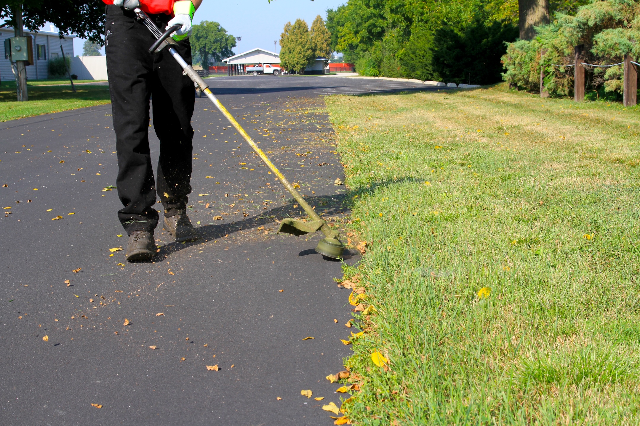 Cleaning and preparing the parking lot with a lawn edger before applying sealcoat and traffic marking paint. Learn how to stripe a parking lot.