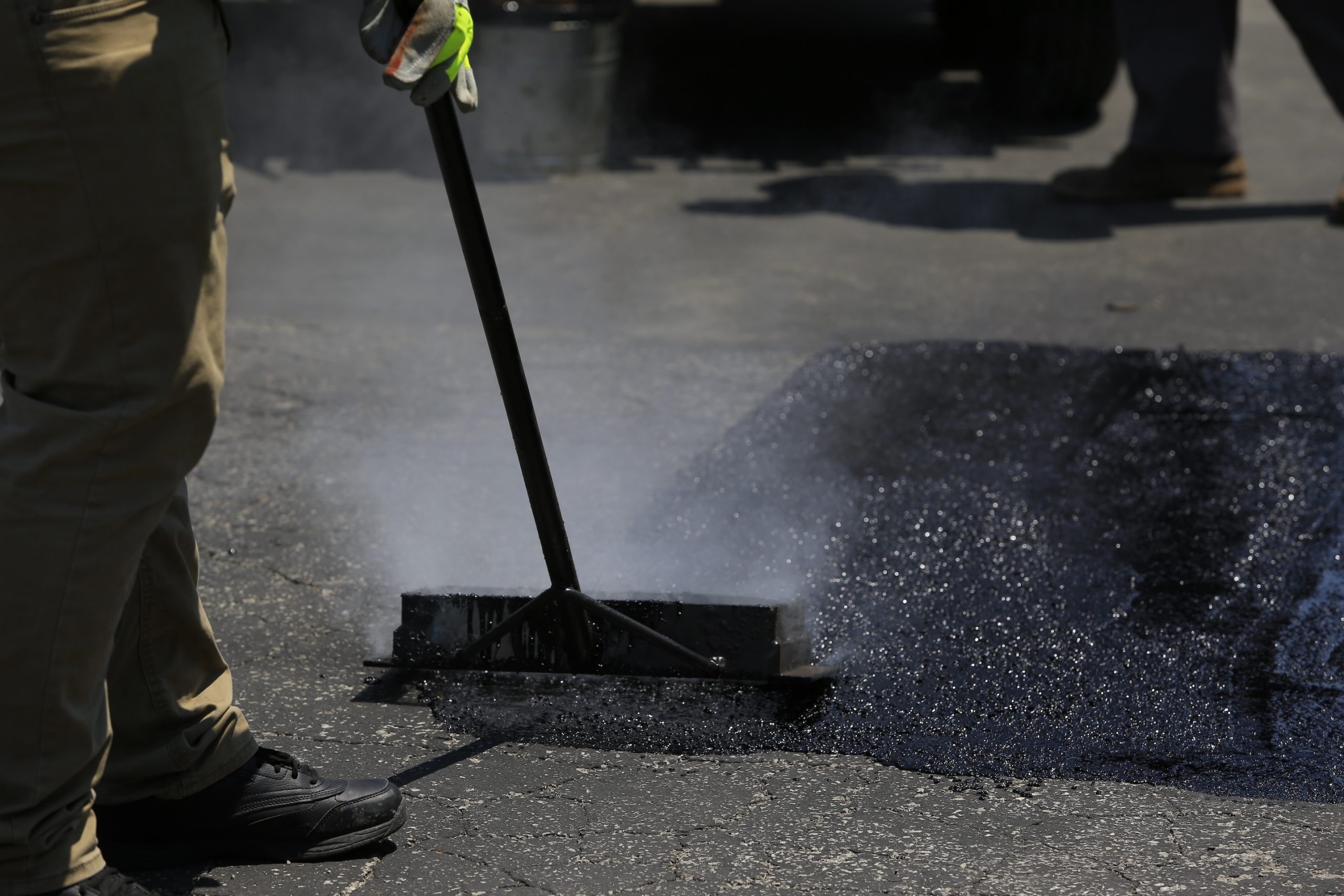 SealMaster mastic application to worn pavement. SealMaster mastic application to worn pavement.