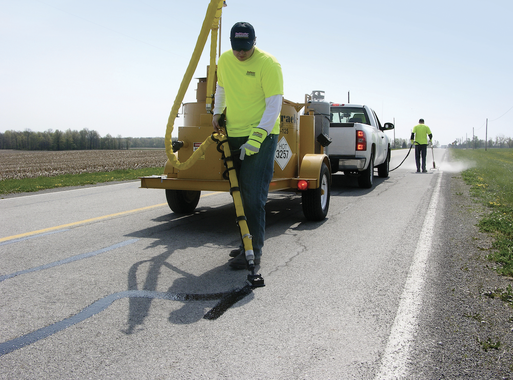 SealMaster CrackPro 125 being used on a road to fill cracks in asphalt pavement.
