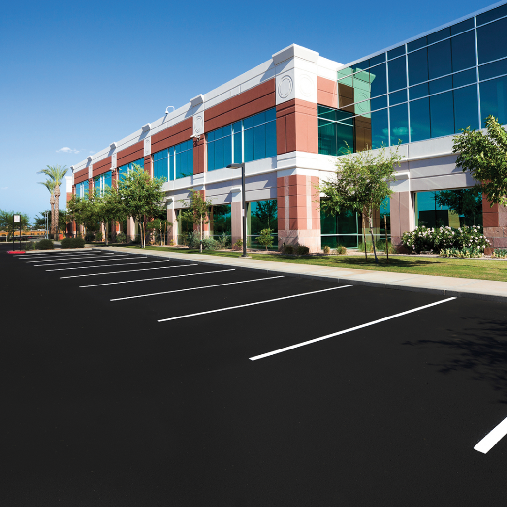 MasterSeal asphalt-based pavement sealer on a business parking lot.